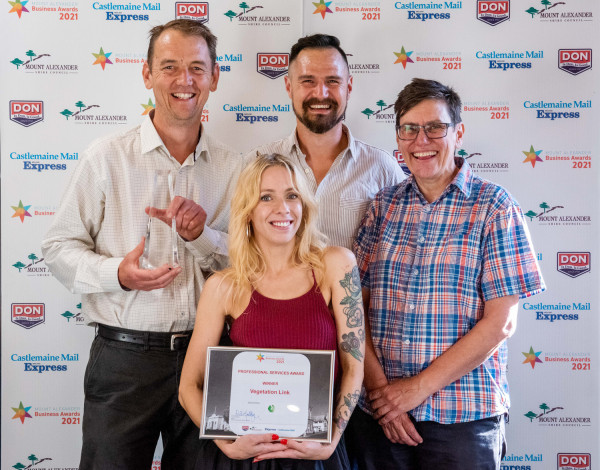 4 people from the Vegetation Link team stand in front of a media wall. One holds crystal trophy. Another holds a certifiate that reads 'Professional Services Award Winner Vegetation Link'.