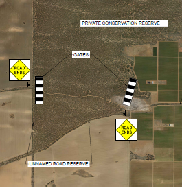Aerial view of a native vegetation offset site amongst farming land with road closure signs at either side of the offset site.
